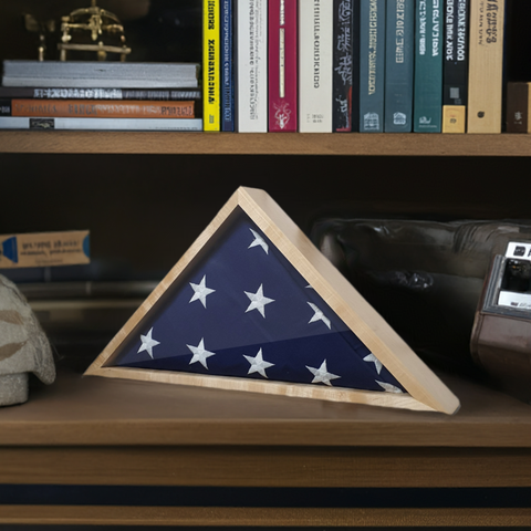 Maple 4'x6' flag display case, handcrafted by Legacies of America Woodworking Co. Displayed in a military Veterans office, sitting on a shelf with books and other military memorabilia.